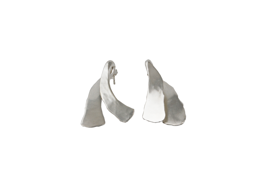 Whirlybird Earrings in Sterling Silver. Inspired by the swirling pods off a maple tree. One leaf is worn on the front of the ear and one on the back, giving it an extra exciting optical twist. 